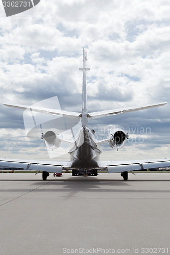 Image of Aircraft learjet Plane in front of the Airport with cloudy sky