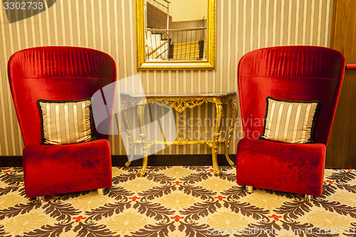 Image of Royal Armchair in red in warm athmosphere decoration