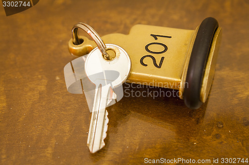 Image of Hotel Room Key lying on Bed with keyring