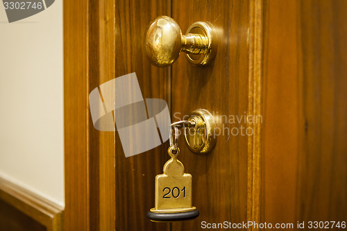 Image of Hotel Room Key lying on Bed with keyring