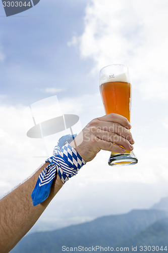 Image of Bavarain man holding wheat beer glass in the air