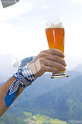 Image of Bavarain man holding wheat beer glass in the air