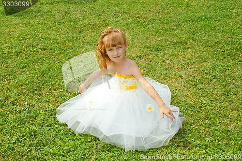 Image of Girl in a festive dress on a lawn