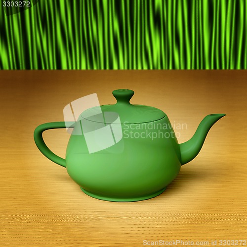 Image of Green teapot on a bamboo mat