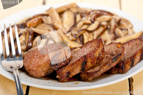 Image of venison deer game filet and wild mushrooms