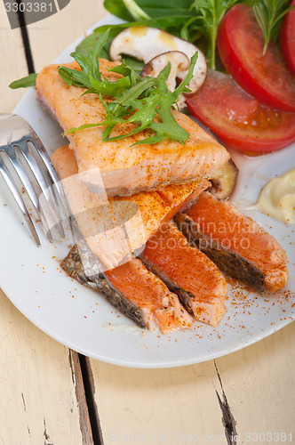 Image of grilled samon filet with vegetables salad