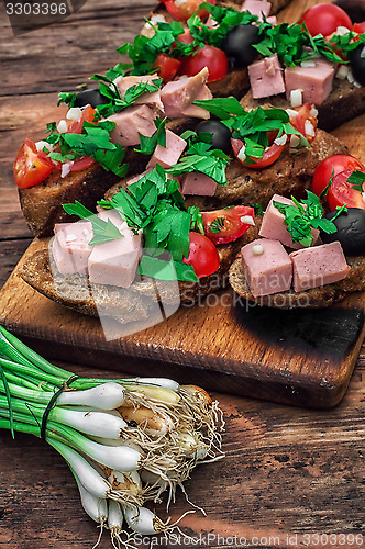 Image of bruschetta with vegetables and meat