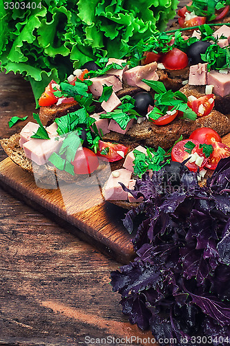 Image of bruschetta with vegetables and meat