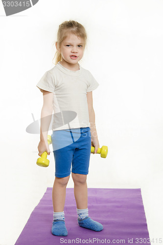 Image of Funny four-year girl with dumbbells