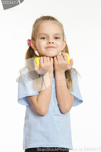 Image of The girl hugged her in the hands of a dumbbell