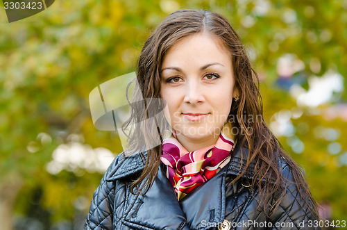 Image of Portrait young girl on a background of autumn leaves