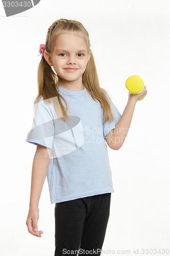 Image of Six year old girl engaged in lifting a dumbbell exercise