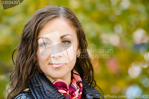 Image of Portrait a twenty-five girls on the background of autumn leaves