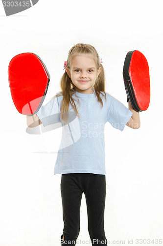 Image of Girl athlete with boxing paws