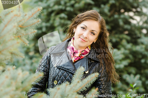 Image of Portrait a twenty-five girls on the background of fir trees