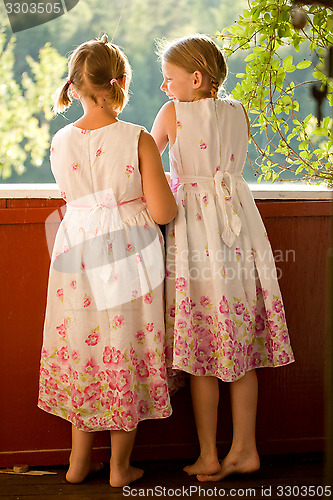 Image of Twin girls in summer dresses