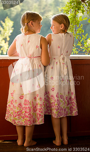 Image of Twin girls in summer dresses