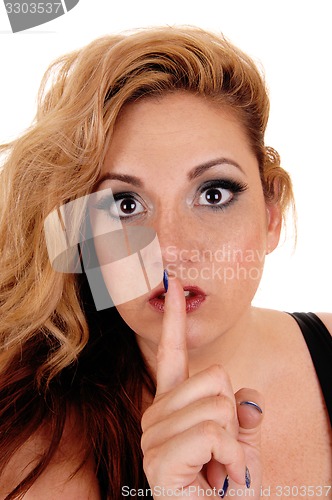 Image of Woman holding finger on mouth.