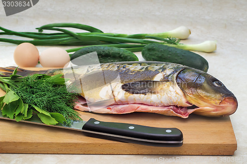 Image of Fish and components for her preparation: vegetables, spices, oni