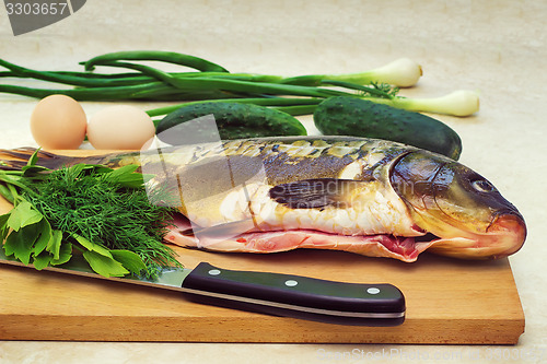 Image of Fish and components for her preparation: vegetables, spices, oni