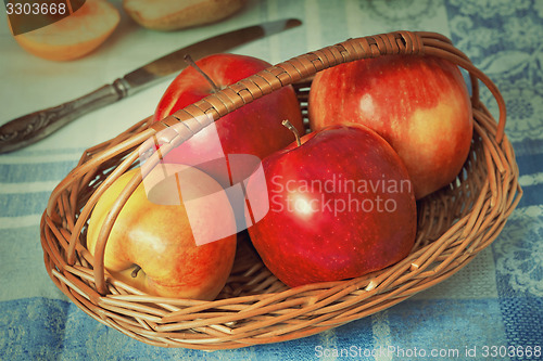 Image of Large apples in a wattled basket.