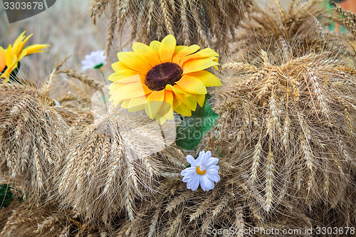 Image of Decoration of artificial flowers and ears of corn.