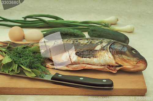 Image of Fish and components for her preparation: vegetables, spices, oni