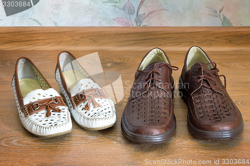 Image of Two pairs of comfortable shoes : for men and for women.