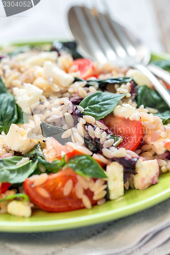 Image of Dish with a salad of pasta orzo, basil and tomatoes.