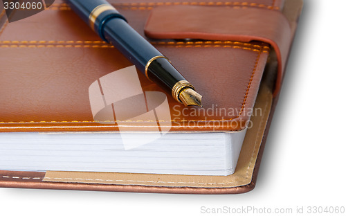 Image of Closeup fountain pen on top of the closed notebook
