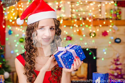 Image of Beautiful girl holding Christmas gift