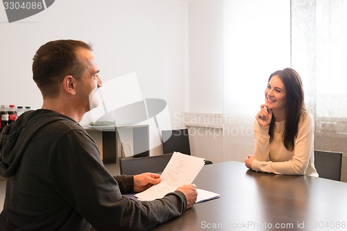 Image of Young female candidate smiling very relaxed during job interview