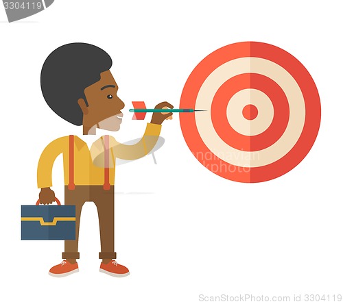 Image of Working black man holding a target arrow 