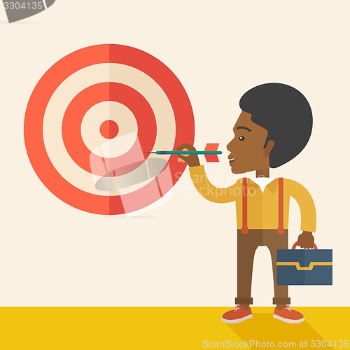 Image of Working black man holding a target arrow 