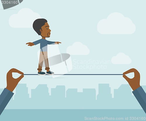 Image of Black Businessman walking on wire.