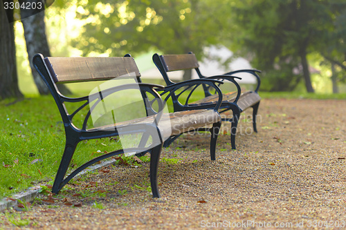 Image of Stylish bench in autumn park