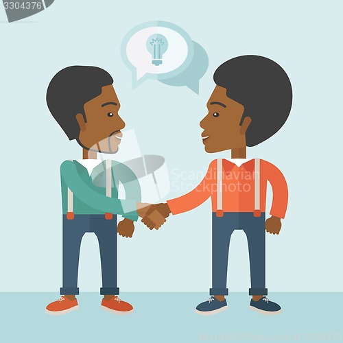 Image of Two African-american guys happily handshaking.