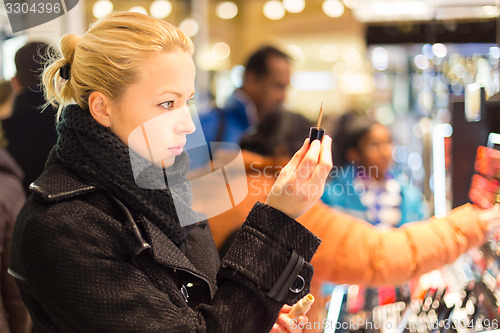 Image of Beautiful woman shopping in beauty store.