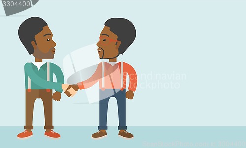 Image of Two African-american guys happily handshaking.