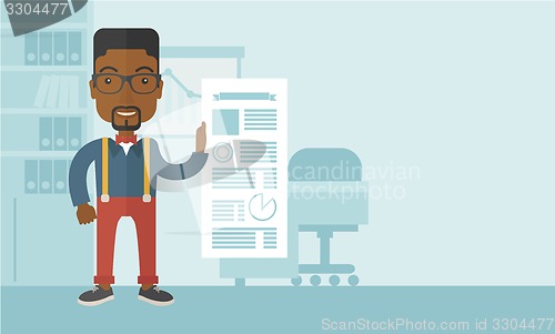 Image of Black man happy standing inside his office.