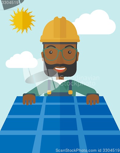 Image of Man putting a solar panel on the roof.