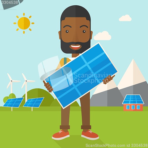 Image of African man holding a solar panel.