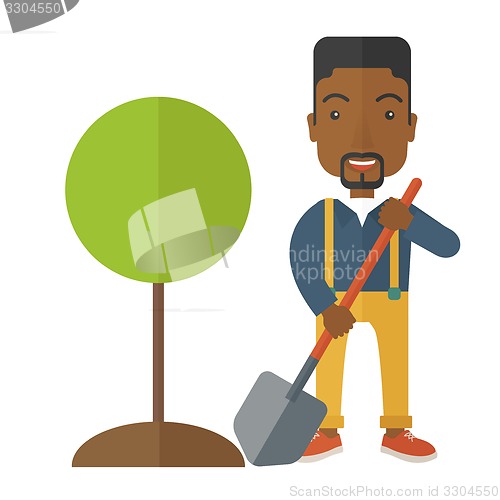 Image of African gardener plant a tree.