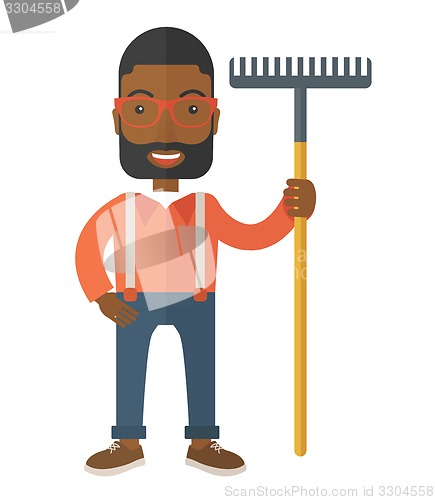 Image of Man with a mustache holding a rake.