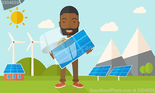 Image of African man holding a solar panel.