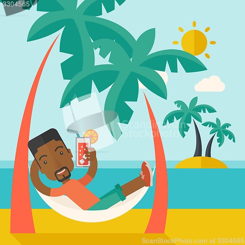 Image of Young black man on th beach relaxing and drinking cocktail.