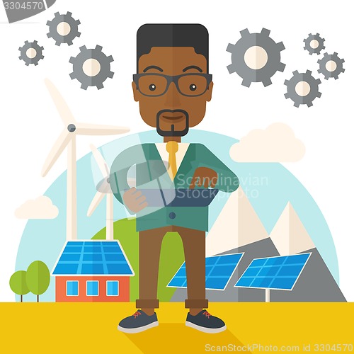 Image of Mid adult male african engineer holding blueprint.