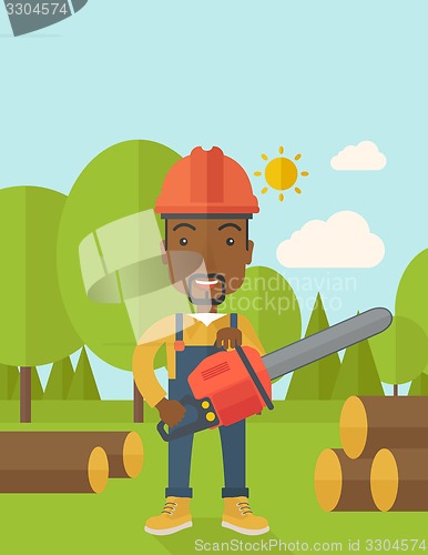 Image of Black Lumberjack cuts a tree by chainsaw.