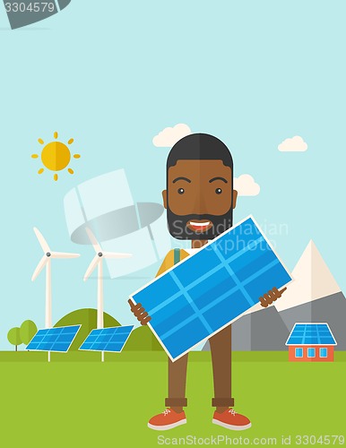 Image of African man holding a solar panel.