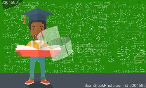 Image of African-american man standing with graduation cap.